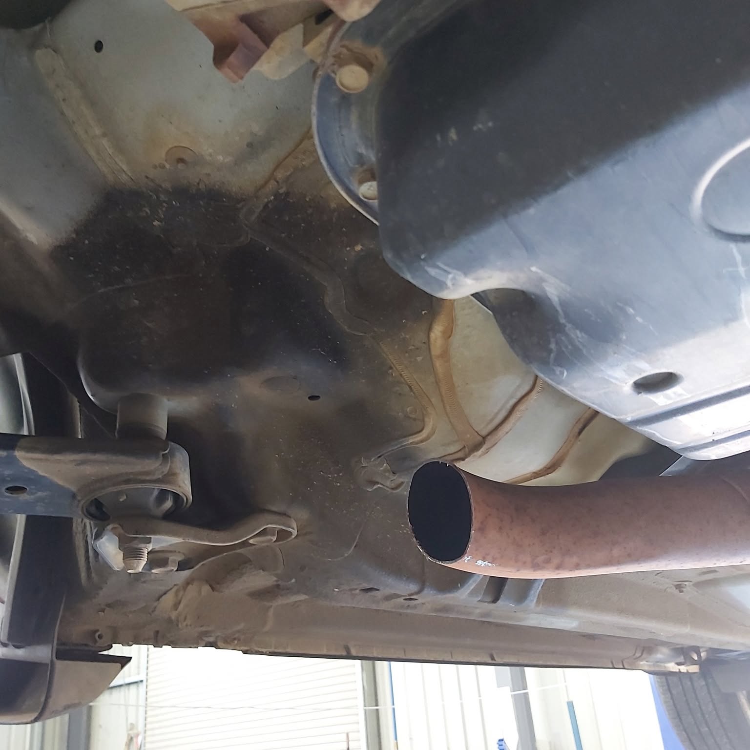 Working underneath a vehicle on the hoist at Baker Automotive